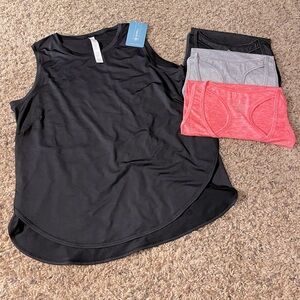 Brand new with tags/packaging workout tanks! Size L/XL